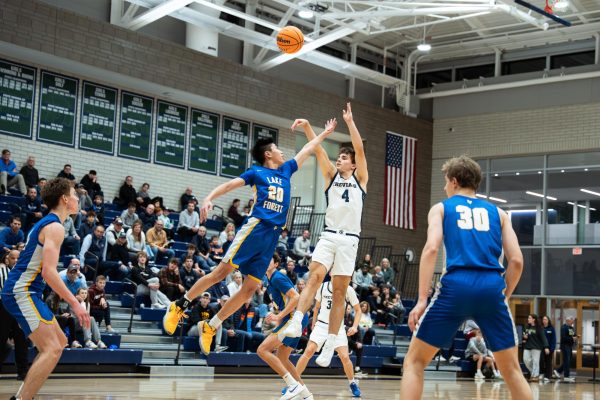 Senior captain Christopher Kirkpatrick pulls up from midrange in the team’s game against Lake Forest High School