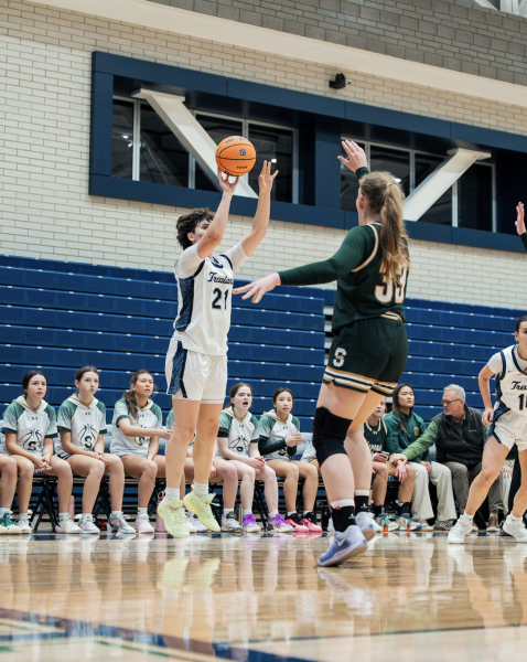 Junior Vic Wainscott shoots a 3-pointer in the 56-40 win over Stevenson High School