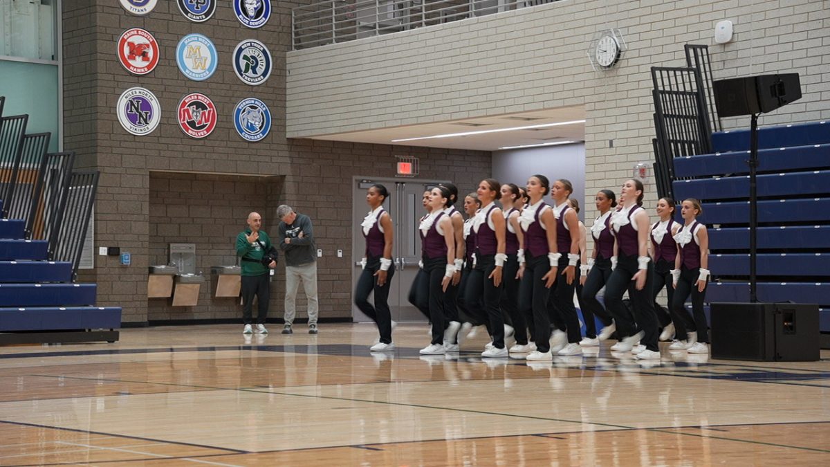The New Trier Dance Team prepares to perform at the CSL competition.