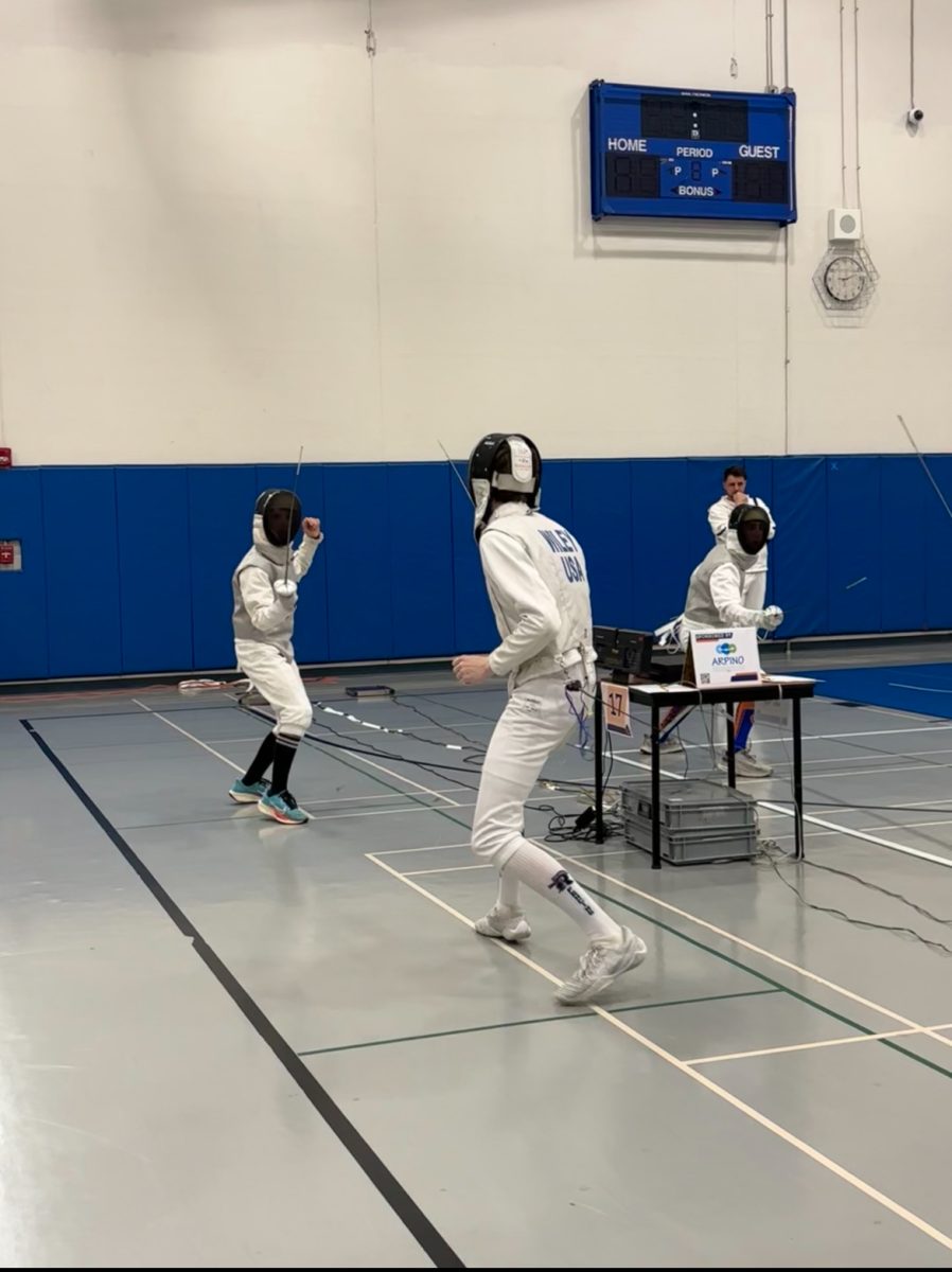 Junior Conor Wiley fences in a bout at the Libertyville High School Open