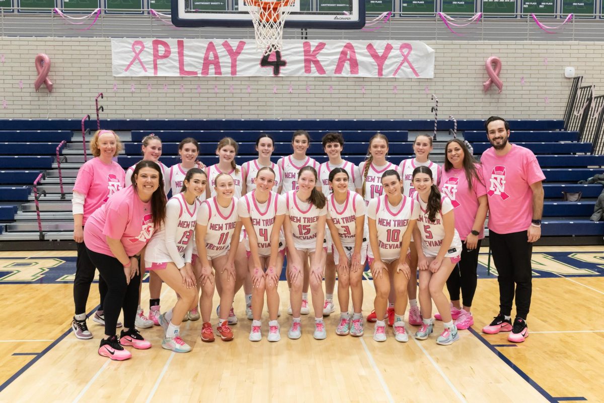 The team poses together after winning the game against Highland Park
