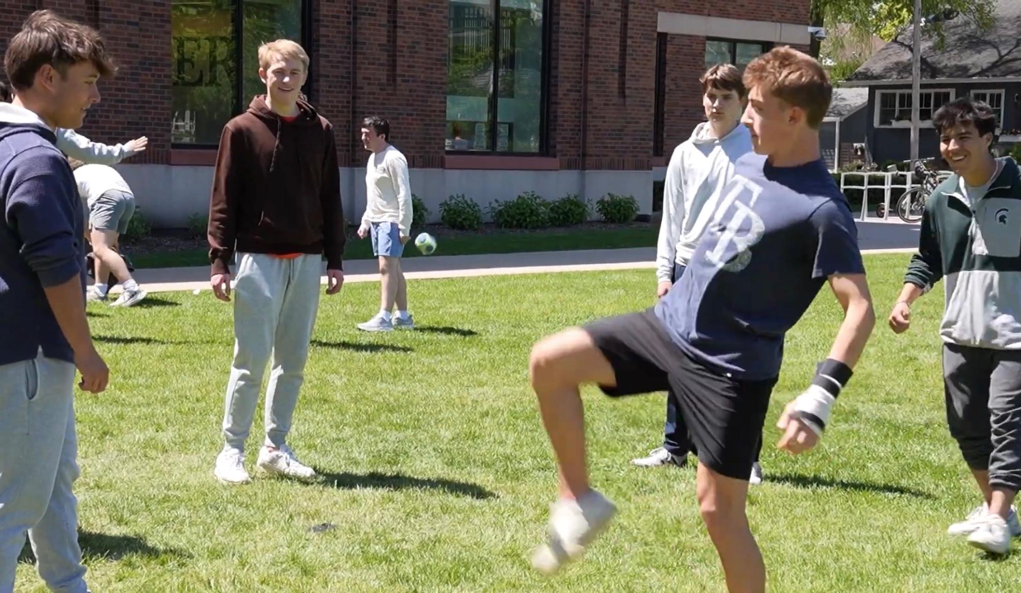 Students play hacky sack on New Trier’s Trevian Way lawn